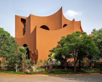 Sculptural terracotta facade with organic wave-like forms