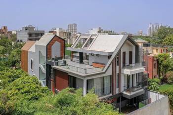 Modern residential house with multi-level facade and contrasting materials