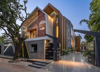 Modern residential house with multi-layered facade: combination of wood, perforation and dynamic lighting