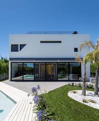 Minimalist white facade with panoramic glazing: contemporary house with rooftop terrace