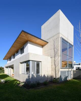 Modern minimalist facade with contrasting combination of concrete and wood