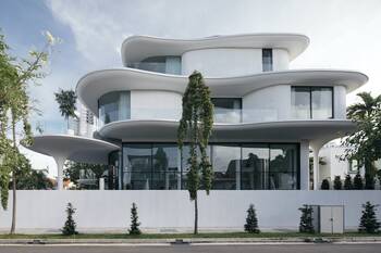 White Wave-Like Facade with Biophilic Elements: Modern Architecture in Urban Environment