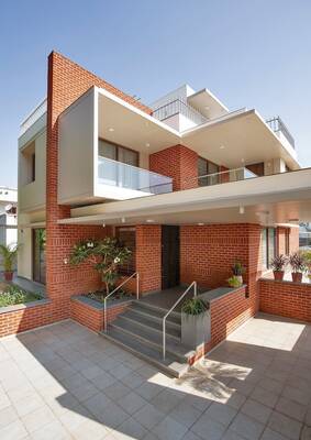 Modern two-story house with a contrasting brick façade