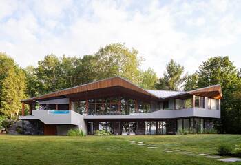 Modern two-level house with dynamic wooden facade and terrace