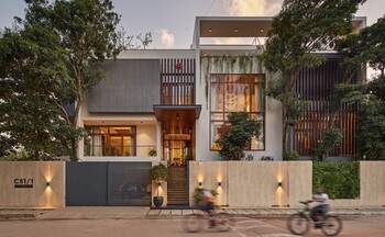 Modern Minimalist Facade with Wooden Slats and Integrated Greenery