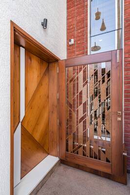 Contemporary wooden facade with geometric pattern: contrast of textures and materials