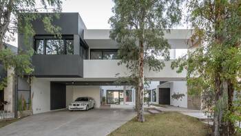 Minimalist Facade with Contrasting Volumes: Contemporary Two-Story House with Integrated Parking