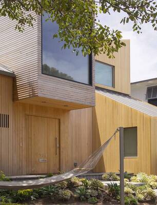 Modern wooden façade with vertical cladding and contrasting textures