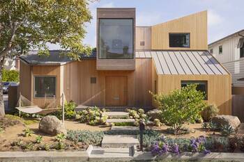 Modern wooden house with dynamic facade and contrasting architectural elements