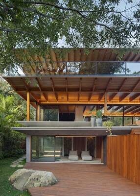 Modern two-story facade with panoramic glazing in natural surroundings