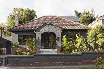 Elegant Gray Bungalow with Terracotta Roof and Arched Facade