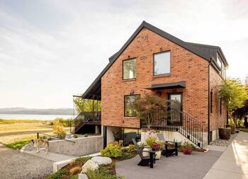 Modern House with Triangular Brick Facade by the Water