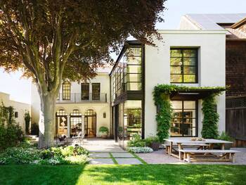 Elegant Duet of Styles: Modern Façade with Classical Elements and Vertical Greenery