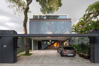 Modern two-story house with ribbed facade and open entrance area