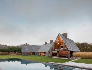 Modern country house with traditional shingle facade: a union of barn architecture and minimalism