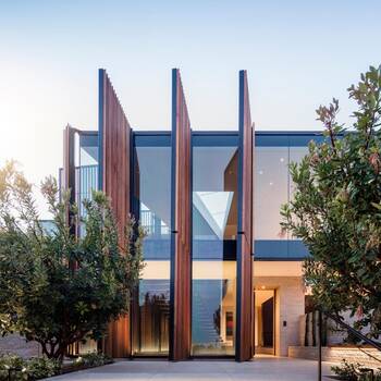 Modern facade with vertical wooden slats and panoramic glazing