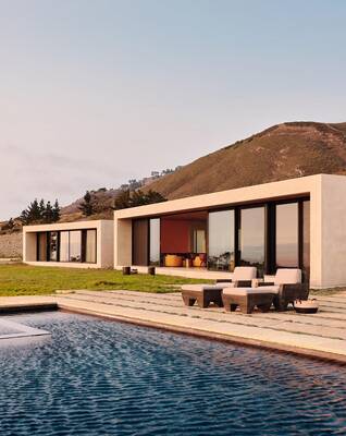 Minimalist Facade of a Mountain House with Panoramic Glazing