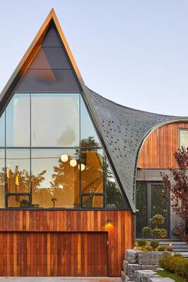 A-frame facade with wooden cladding and panoramic glazing