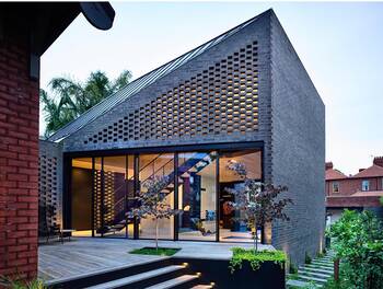 Modern House with Perforated Brick Facade and Glass Insertions