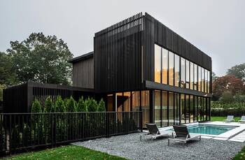 Minimalist Black Facade with Vertical Lamellae and Panoramic Glazing