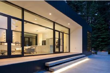 Minimalist glass facade with panoramic windows and integrated lighting