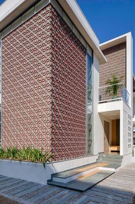 Modern house with perforated facade creating geometric pattern