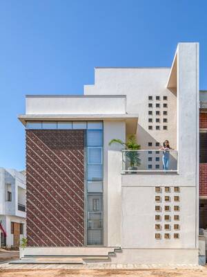 Modern residential house with contrasting facade: combination of white geometry and ornamental panels