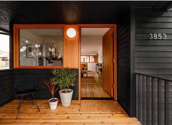 Contrasting facade of a modern house with wooden portal