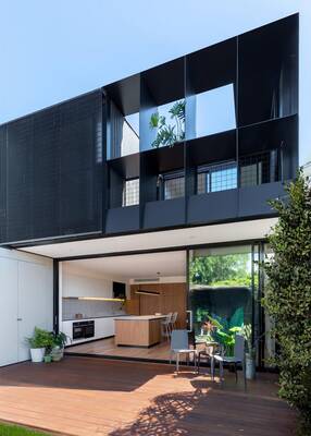 Modern two-story house with contrasting facade: dark top and light bottom