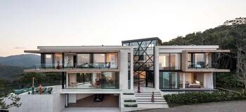 Contemporary villa with dynamic facade: interplay of geometry, glass, and space