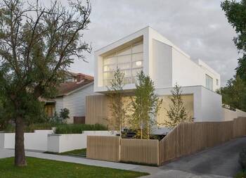 White cube with wooden accents: minimalist facade of a modern house