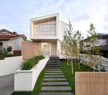 Minimalist White Facade with Wooden Accents and Panoramic Glazing