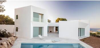 Mediterranean snow-white villa with minimalist façade and blue accents