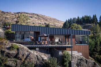 Modern mountain house with contrasting metal and wood facade