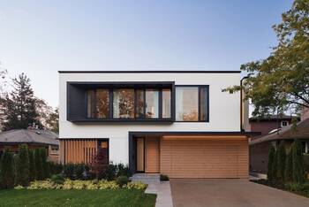 Modern minimalist facade with contrasting combination of white stucco and wooden elements