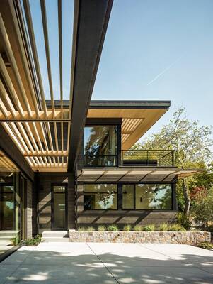 Modern facade with wooden slats and cantilevered projection