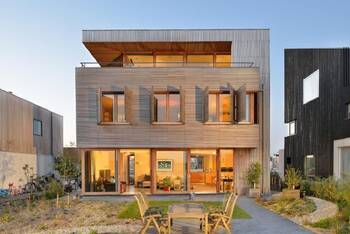 Modern wooden facade with adjustable shutters and panoramic glazing