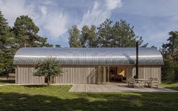 Modern barn house with aluminum roof and wooden facade