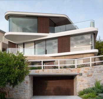 Modern Curved Facade: A Blend of Stone, Glass, and Textured Panels