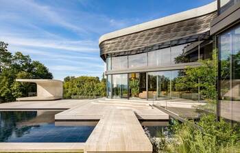 Modern villa with panoramic curved façade and landscape integration