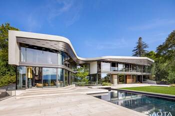 Flowing Facade of a Modern Mansion with Panoramic Glazing