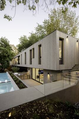 Cantilevered House with Wooden Facade: Minimalism and Harmony with Nature