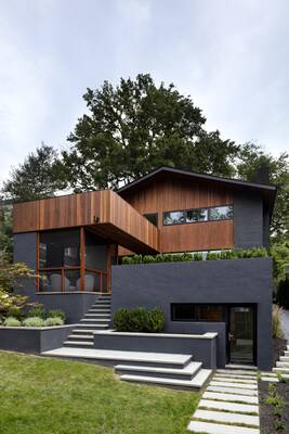 Modern two-level house with contrasting wood and concrete facade