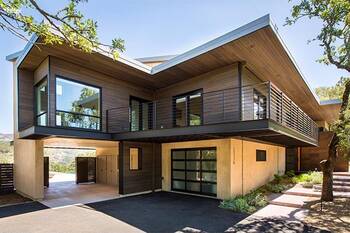 Modern two-story house with contrasting wood and concrete facade