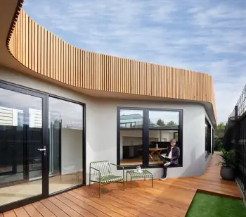 Modern house with curved wooden facade and open terrace