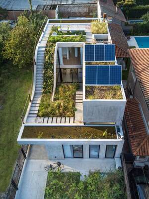 Modern eco-house with green roof and minimalist concrete facade