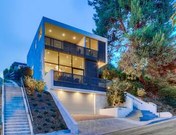 Minimalist Facade of a Modern Hillside House with Panoramic Glazing