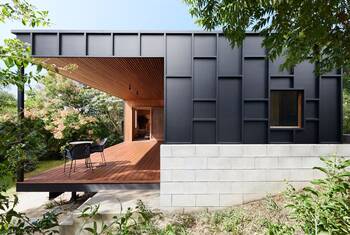 Modern facade with contrasting combination of metal, concrete and wood