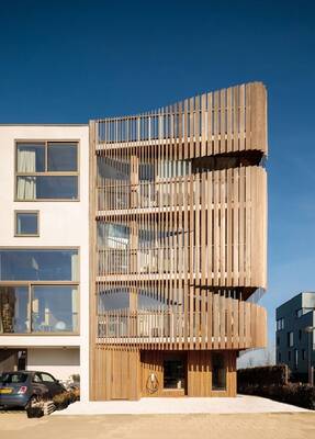 Bioclimatic wooden facade with rhythmic slats