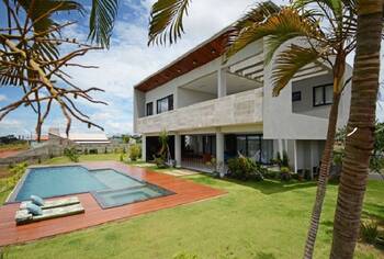 Modern tropical villa with minimalist facade and open terrace